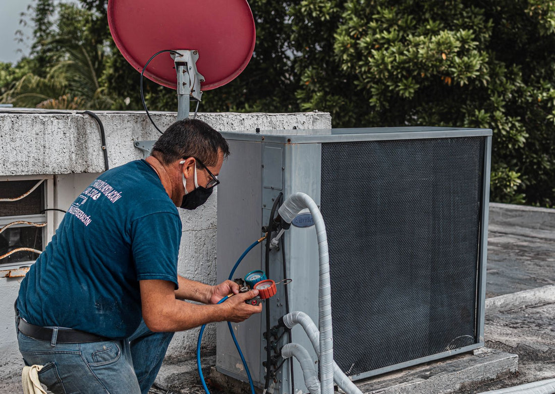 HVAC technician servicing an air conditioner