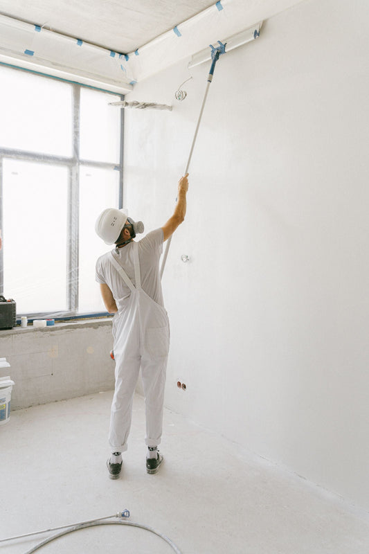 Professional painter applying paint to an interior wall